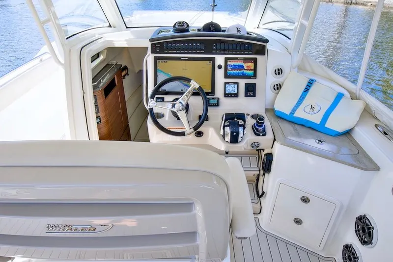Slide: The Image of Cockpit of 2019 Boston Whaler 350 Realm with advanced navigation controls. - 15