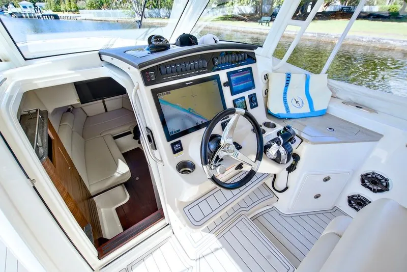 Slide: The Image of 2019 Boston Whaler 350 Realm cockpit with advanced navigation system and luxurious seating. - 17