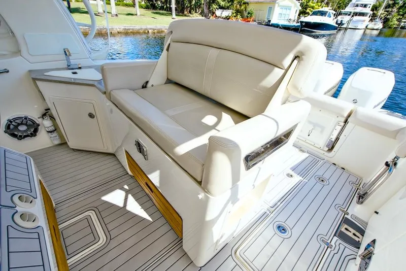Slide: The Image of 2019 Boston Whaler 350 Realm interior with seating and deck view. - 18