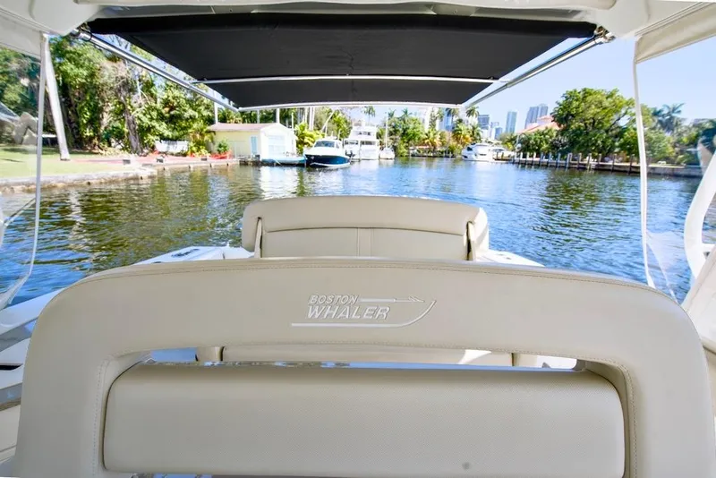 Slide: The Image of 2019 Boston Whaler 350 Realm boat interior with waterfront view. - 22