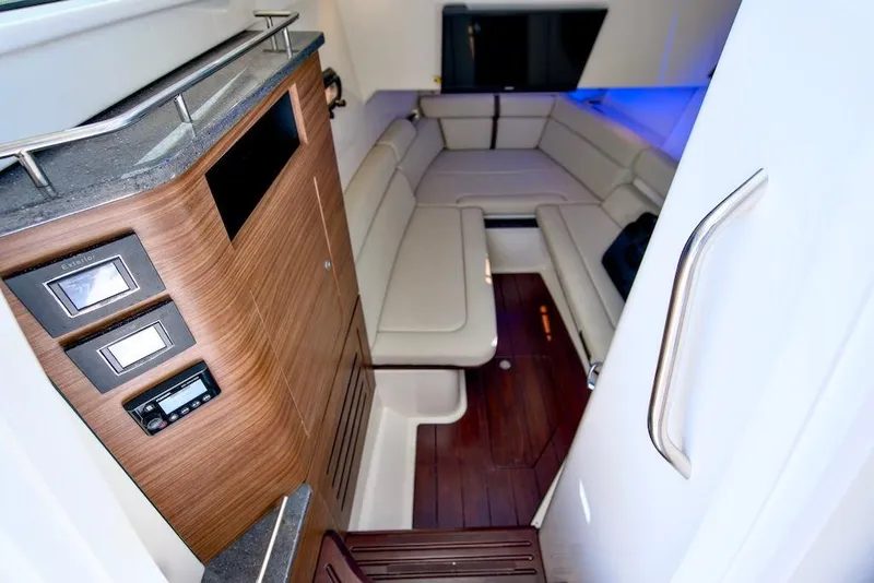 Slide: The Image of Interior of 2019 Boston Whaler 350 Realm with wood accents and seating area. - 26
