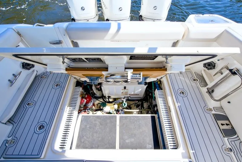 Slide: The Image of 2019 Boston Whaler 350 Realm engine compartment with open hatch, showcasing mechanical components. - 31