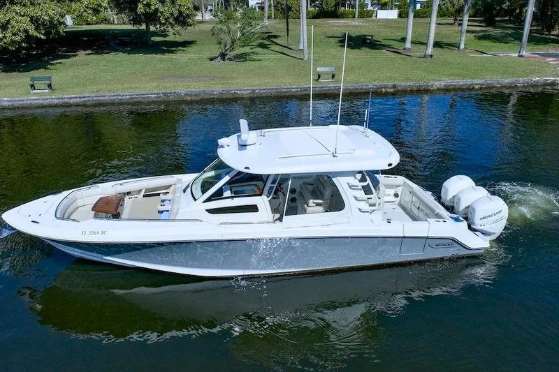Slide: The Image of 2019 Boston Whaler 350 Realm boat cruising on a calm waterway. - 7