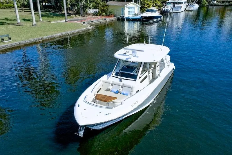 Slide: The Image of 2019 Boston Whaler 350 Realm boat cruising on a serene waterway. - 8