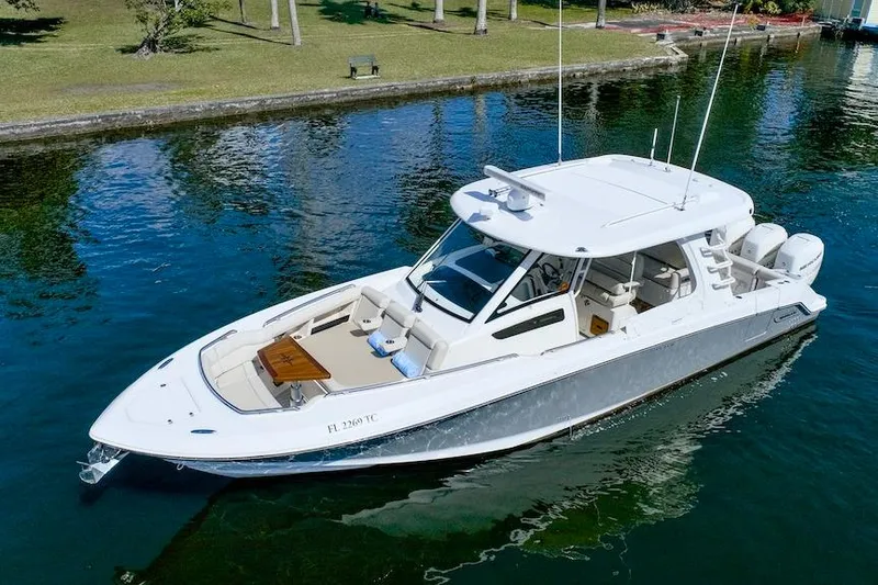 Slide: The Image of 2019 Boston Whaler 350 Realm boat on calm water, showcasing sleek design and luxury features. - 9