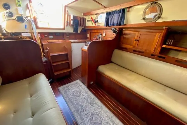 Slide: The Image of 1979 Morgan 321 yacht interior with wooden cabinetry and cozy seating area. - 18