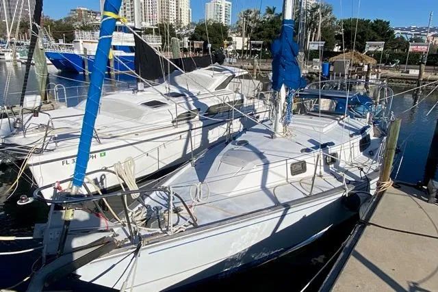 Slide: The Image of 1979 Morgan 321 sailboat docked at a marina, surrounded by other boats. - 2
