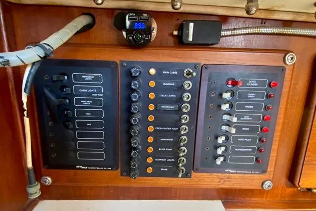 Slide: The Image of Control panel of a 1979 Morgan 321 boat with various switches and dials. - 22