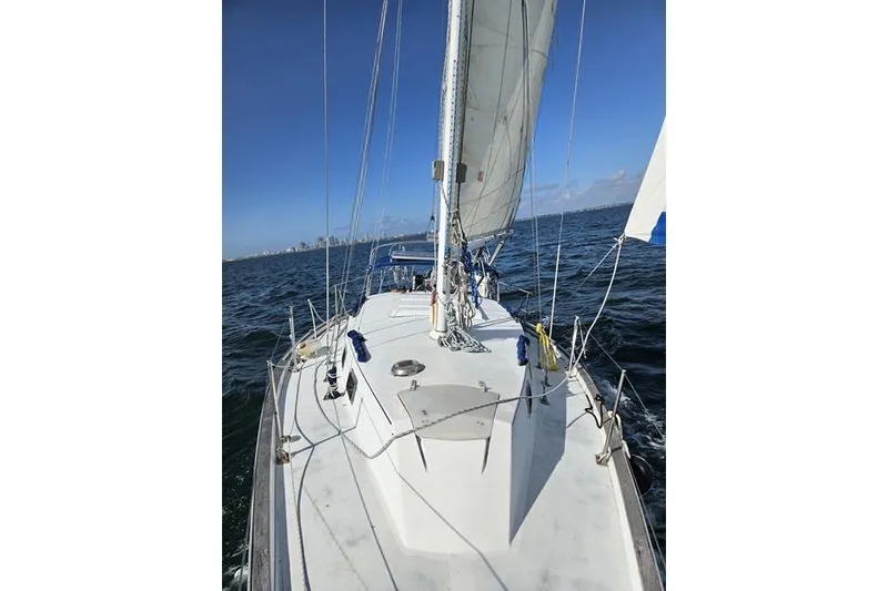 Slide: The Image of Sailing on a 1979 Morgan 321 yacht with clear blue skies and ocean view. - 27