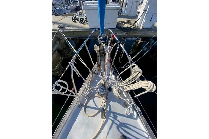 Slide: The Image of Bow of a 1979 Morgan 321 sailboat with ropes and rigging at a marina. - 4