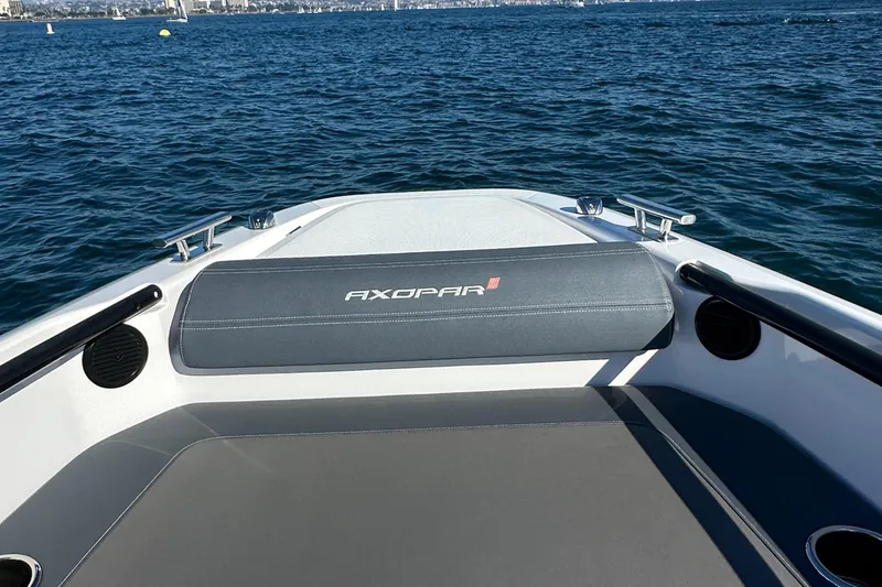 Slide: The Image of Axopar 22 Spyder 2021 boat on water, featuring sleek seating and open deck design. - 13