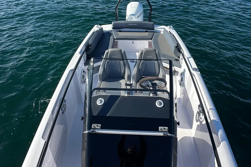 Slide: The Image of 2021 Axopar 22 Spyder boat on water, featuring sleek design and modern seating. - 16