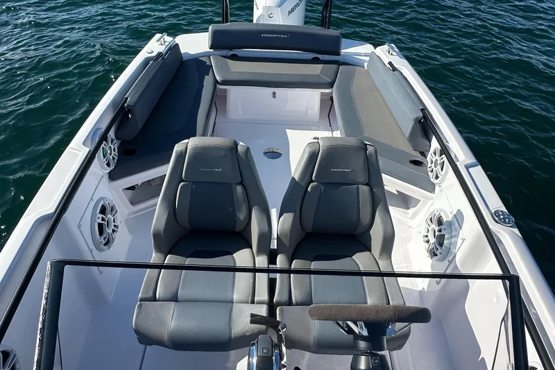 Slide: The Image of 2021 Axopar 22 Spyder boat interior with gray seating and steering wheel. - 17