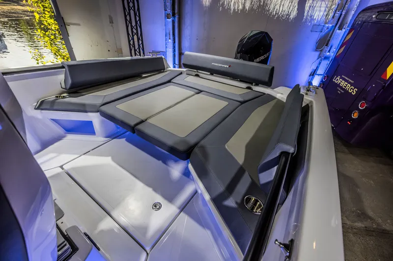 Slide: The Image of 2021 Axopar 22 Spyder interior with cushioned seating and modern design. - 33