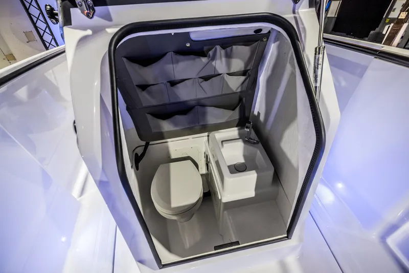 Slide: The Image of 2021 Axopar 22 Spyder boat interior with compact toilet and sink. - 34