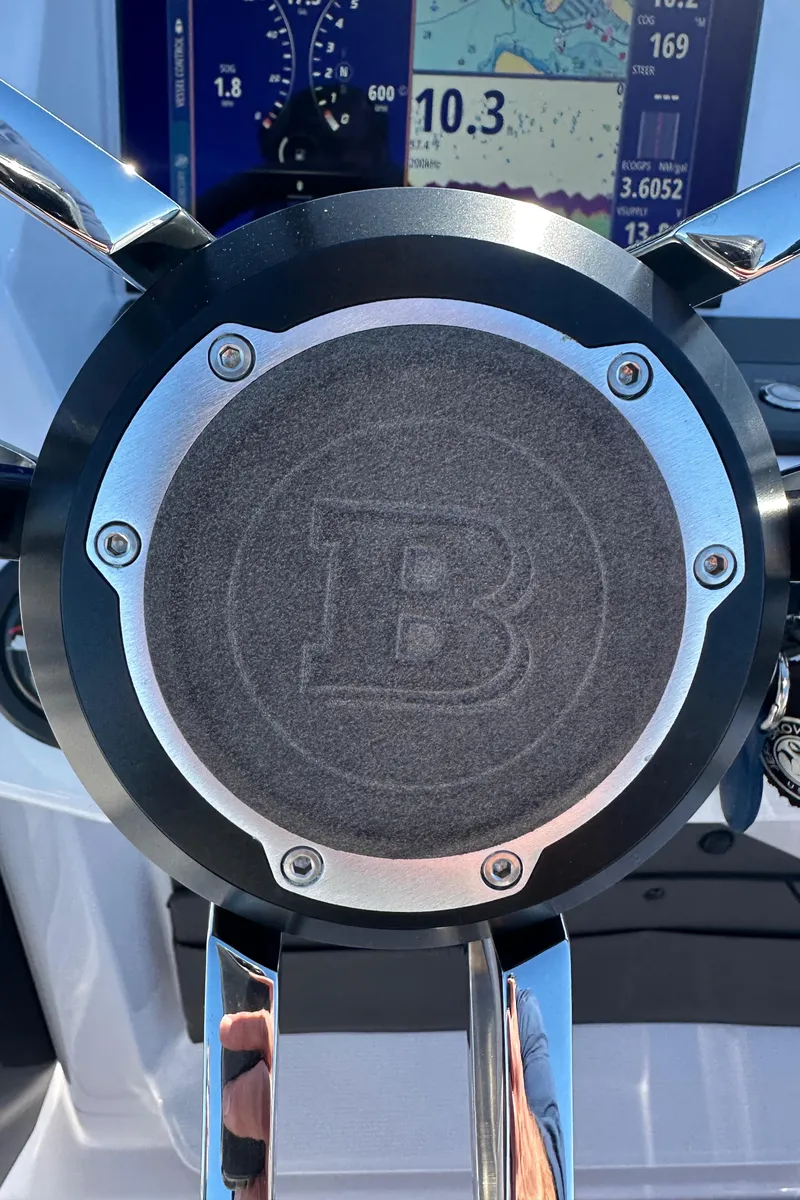 Slide: The Image of Steering wheel of 2021 Axopar 22 Spyder boat with dashboard display. - 8