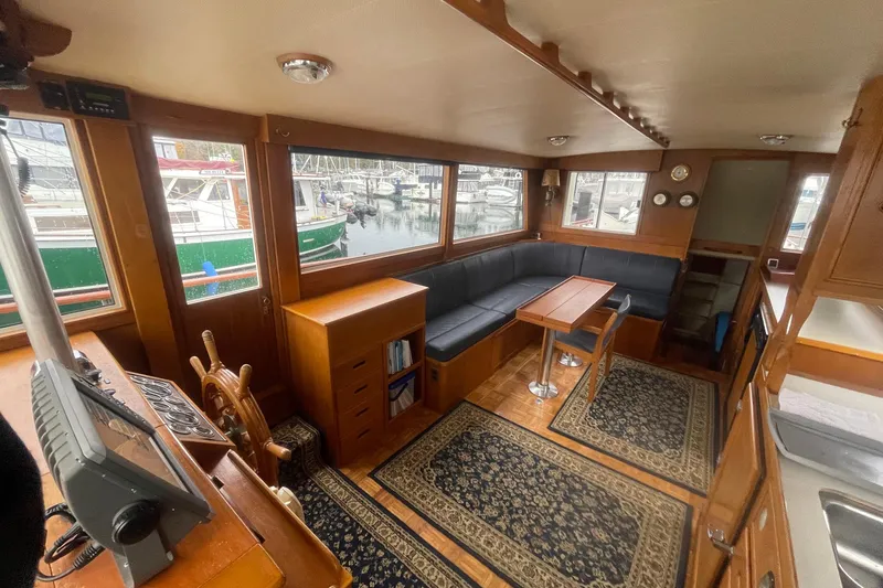 Slide: The Image of Interior of a 1974 Grand Banks 42 Motoryacht with wood finish and seating area. - 21