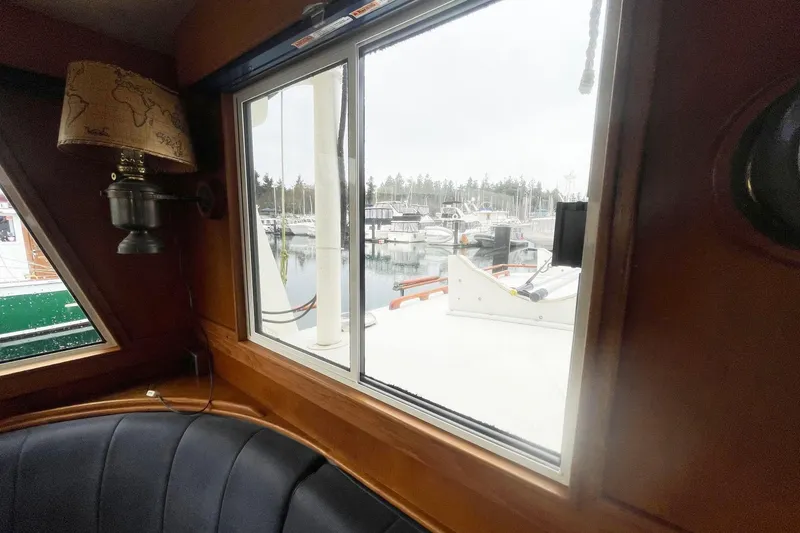 Slide: The Image of Interior view from 1974 Grand Banks 42 Motoryacht, showcasing marina through window. - 23