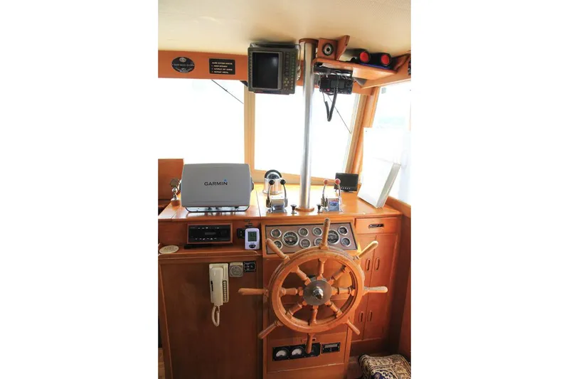 Slide: The Image of 1974 Grand Banks 42 Motoryacht helm with wooden wheel and navigation equipment. - 24