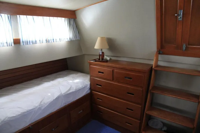Slide: The Image of 1974 Grand Banks 42 Motoryacht cabin with wooden furniture and cozy bed. - 32