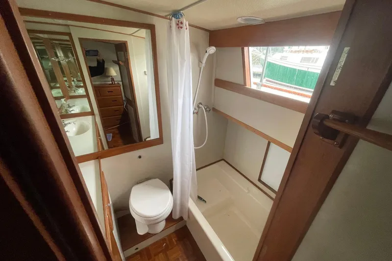 Slide: The Image of 1974 Grand Banks 42 Motoryacht bathroom with shower, toilet, and mirror. - 42