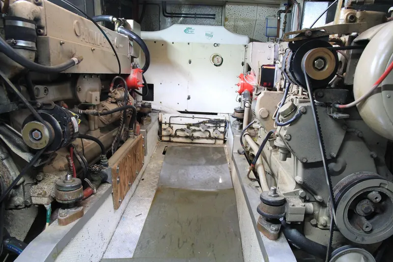 Slide: The Image of Engine room of a 1974 Grand Banks 42 Motoryacht, showcasing mechanical components. - 43