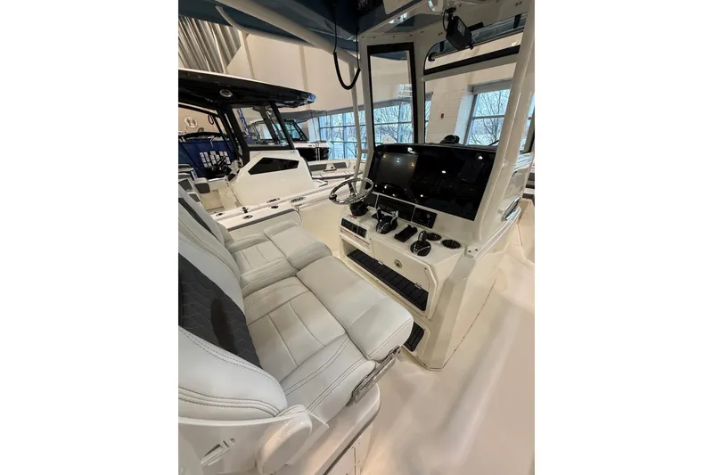Slide: The Image of 2026 Cobia 285 Center Console boat interior with modern helm and seating. - 11