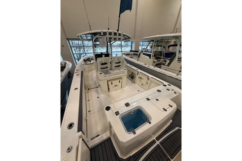 Slide: The Image of 2026 Cobia 285 Center Console boat interior with seating and storage compartments. - 2