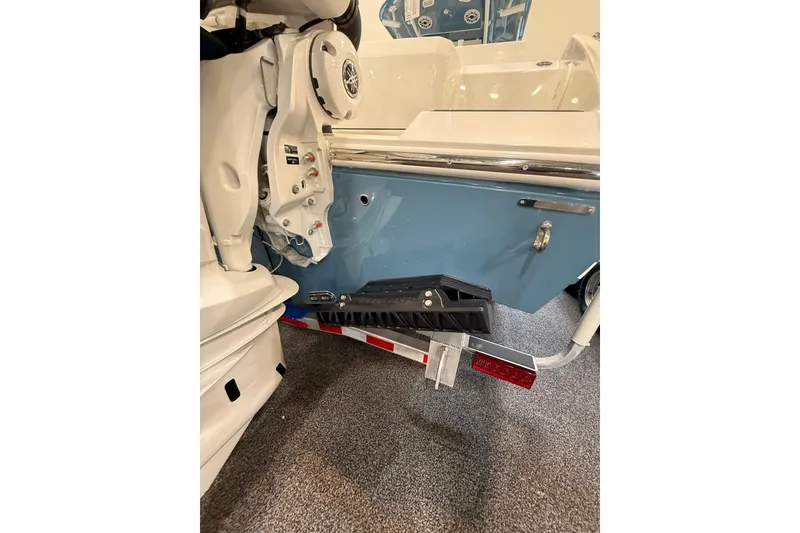 Slide: The Image of 2026 Cobia 285 Center Console boat on trailer, showcasing rear view and motor details. - 4