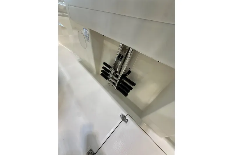 Slide: The Image of 2026 Cobia 285 Center Console boat interior with rod holders and storage compartment. - 10
