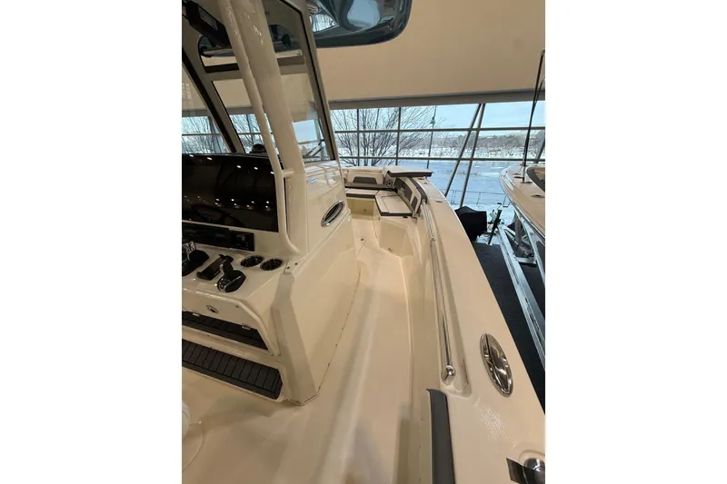 Slide: The Image of 2026 Cobia 285 Center Console boat interior with modern controls and spacious deck. - 13