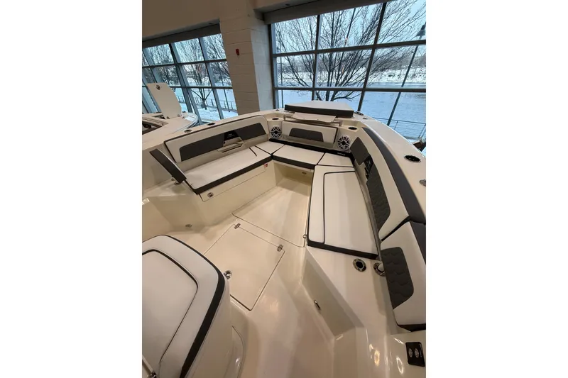 Slide: The Image of 2026 Cobia 285 Center Console boat interior with cushioned seating and modern design. - 14