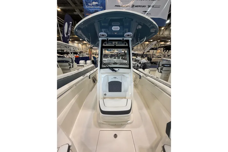 Slide: The Image of 2026 Cobia 285 Center Console boat displayed at an indoor marina event. - 15