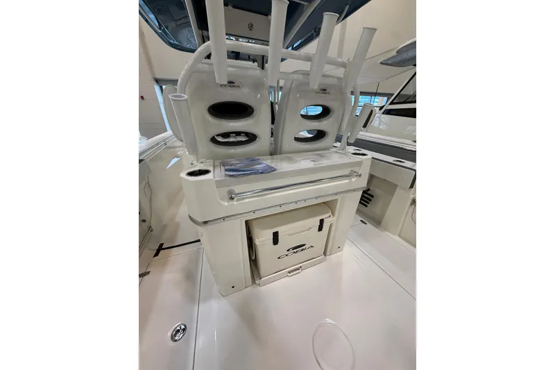 Slide: The Image of 2026 Cobia 285 Center Console boat interior with rod holders and storage compartments. - 8