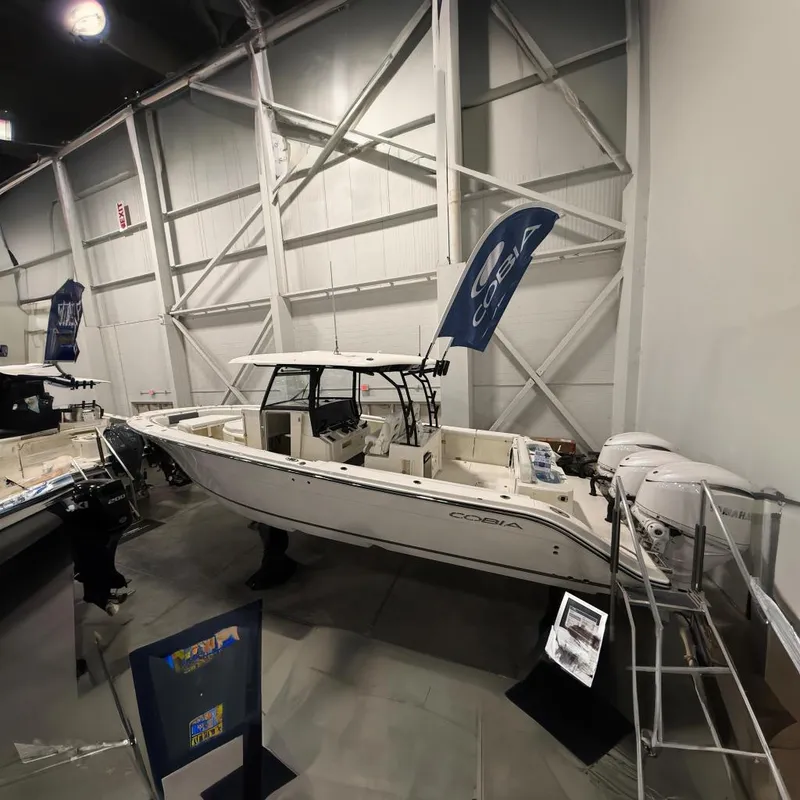 Slide: The Image of 2026 Cobia 350 Center Console boat in an exhibition hall. - 0