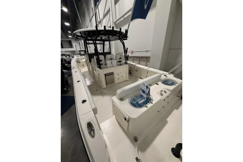 Slide: The Image of 2026 Cobia 350 Center Console boat displayed indoors, showcasing spacious deck and seating. - 15