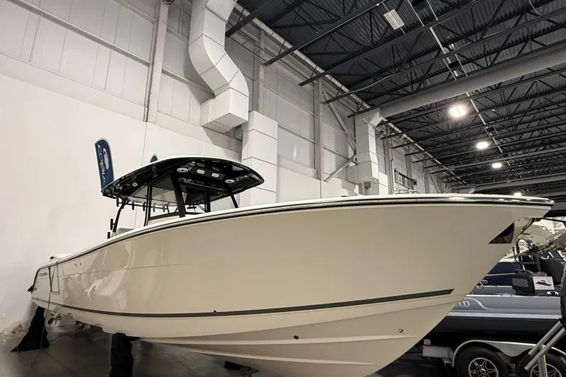 Slide: The Image of 2026 Cobia 350 Center Console boat displayed indoors, showcasing sleek design and modern features. - 2
