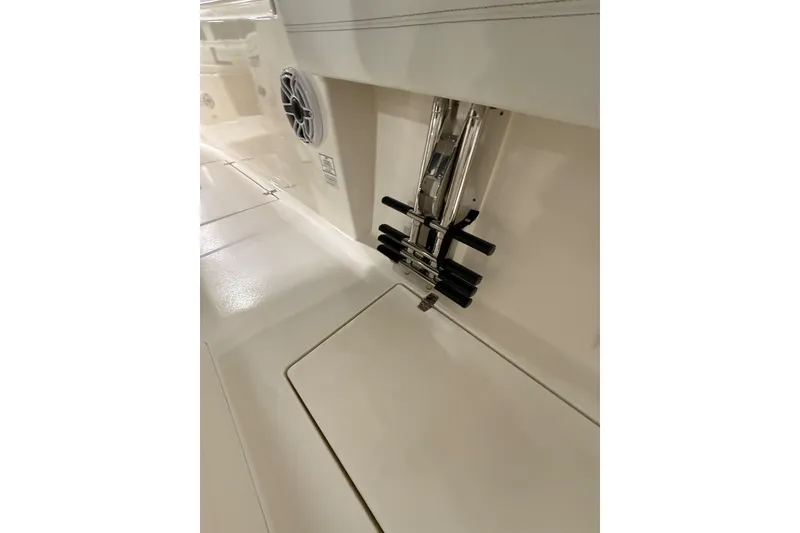 Slide: The Image of 2026 Cobia 350 Center Console boat interior with speaker and rod holders. - 21