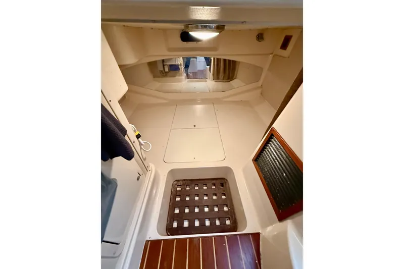 Slide: The Image of 2002 Grady-White Express 330 cabin interior with wooden flooring and storage compartments. - 20