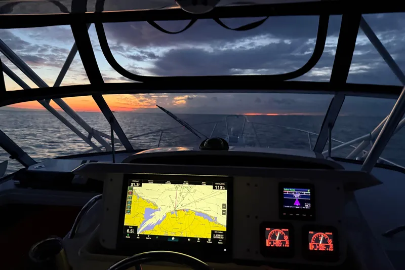 Slide: The Image of 2002 Grady-White Express 330 boat lifted by crane at marina. - 3