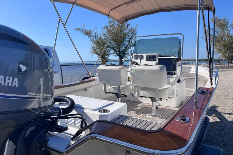 Slide: The Image of 1998 Cape Horn 23 Cape Bay boat with Yamaha engine, featuring dual seats and canopy. - 11