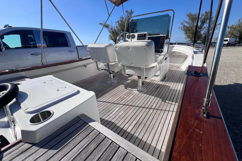 Slide: The Image of 1998 Cape Horn 23 Cape Bay boat interior with seating and steering console. - 13