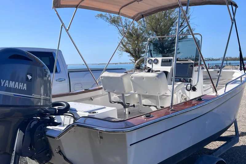 Slide: The Image of 1998 Cape Horn 23 Cape Bay boat with Yamaha engine, parked near water. - 14