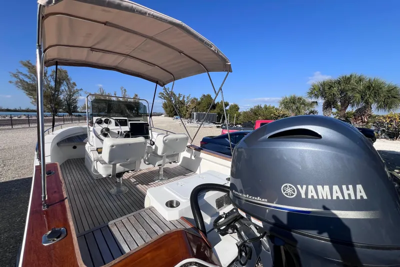 Slide: The Image of 1998 Cape Horn 23 Cape Bay boat with Yamaha engine, featuring dual seats and canopy. - 16