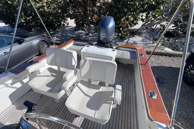 Slide: The Image of 1998 Cape Horn 23 Cape Bay boat with dual seats and outboard motor. - 21