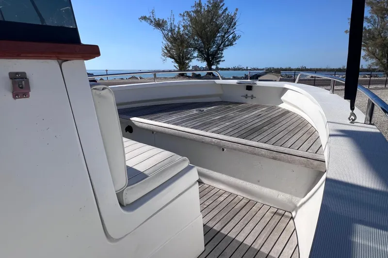 Slide: The Image of 1998 Cape Horn 23 Cape Bay boat with spacious deck and seating, docked by the shore. - 27