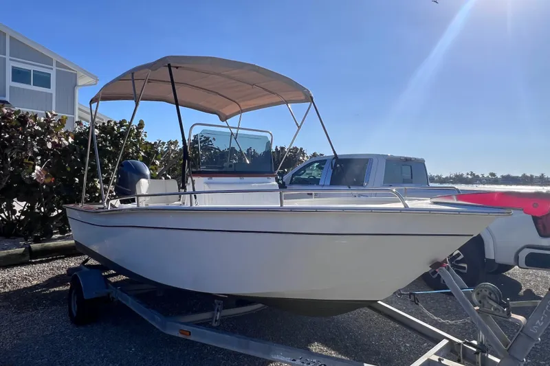 Slide: The Image of 1998 Cape Horn 23 Cape Bay boat on trailer with canopy, parked outdoors. - 3