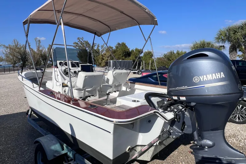 Slide: The Image of 1998 Cape Horn 23 Cape Bay boat with Yamaha outboard motor, parked on a trailer. - 6