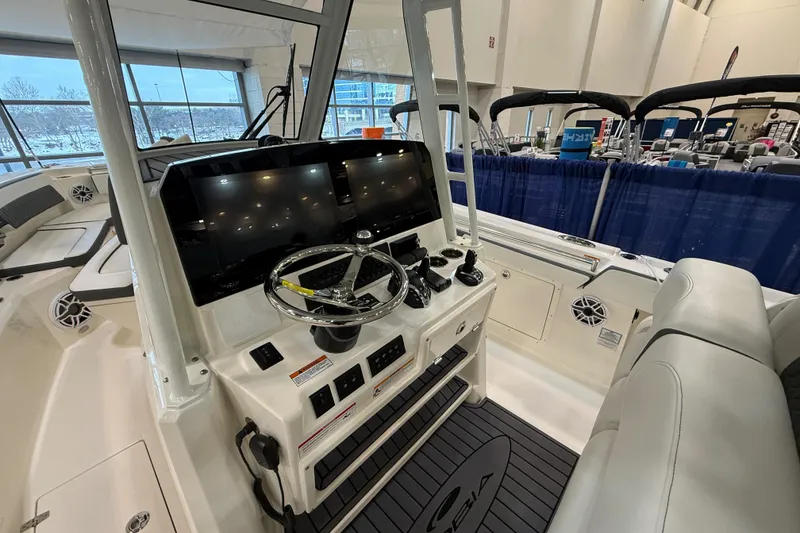 Slide: The Image of 2026 Cobia 305 Center Console boat interior with modern helm and dual displays. - 10