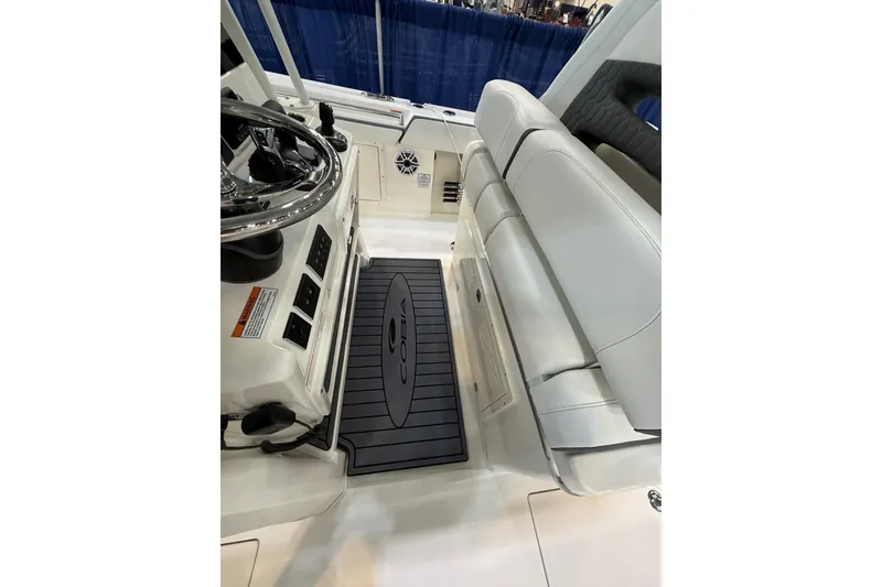 Slide: The Image of 2026 Cobia 305 Center Console interior with steering wheel and cushioned seating. - 11